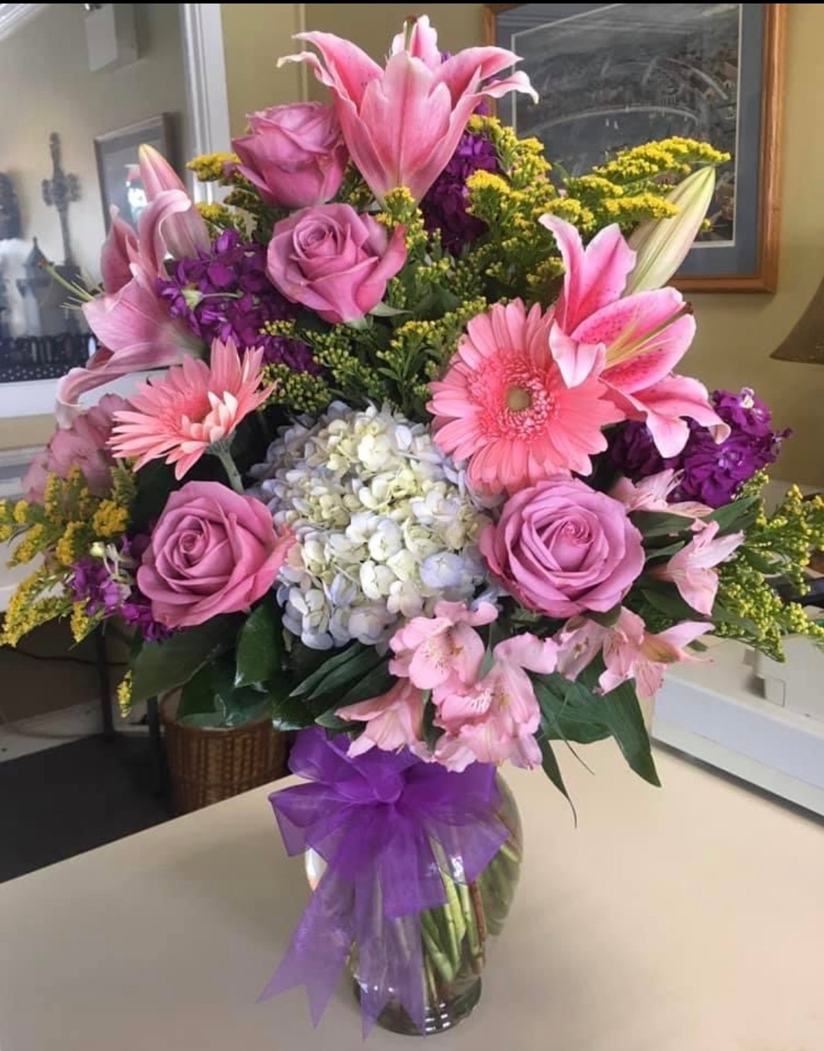 Everyday floral arrangement with pink lilies, roses, gerberas, white hydrangeas and purple accents