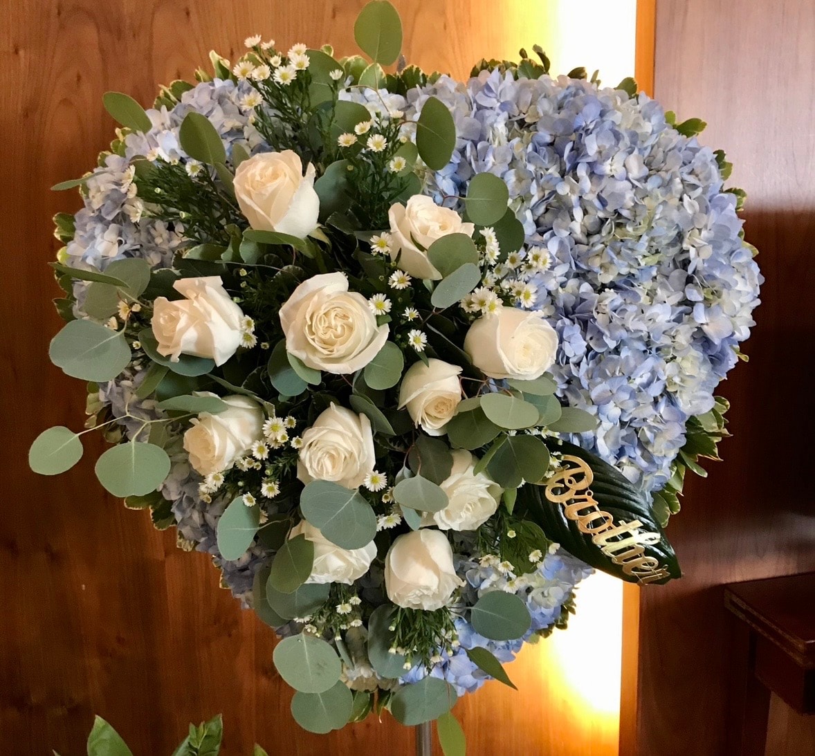 Heart-shaped floral arrangement with white roses